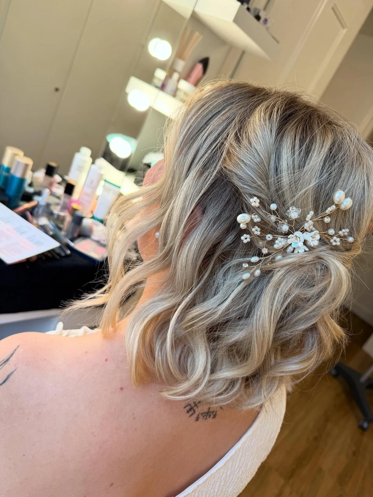 Coiffure de mariée avec accessoire fleurs et perles